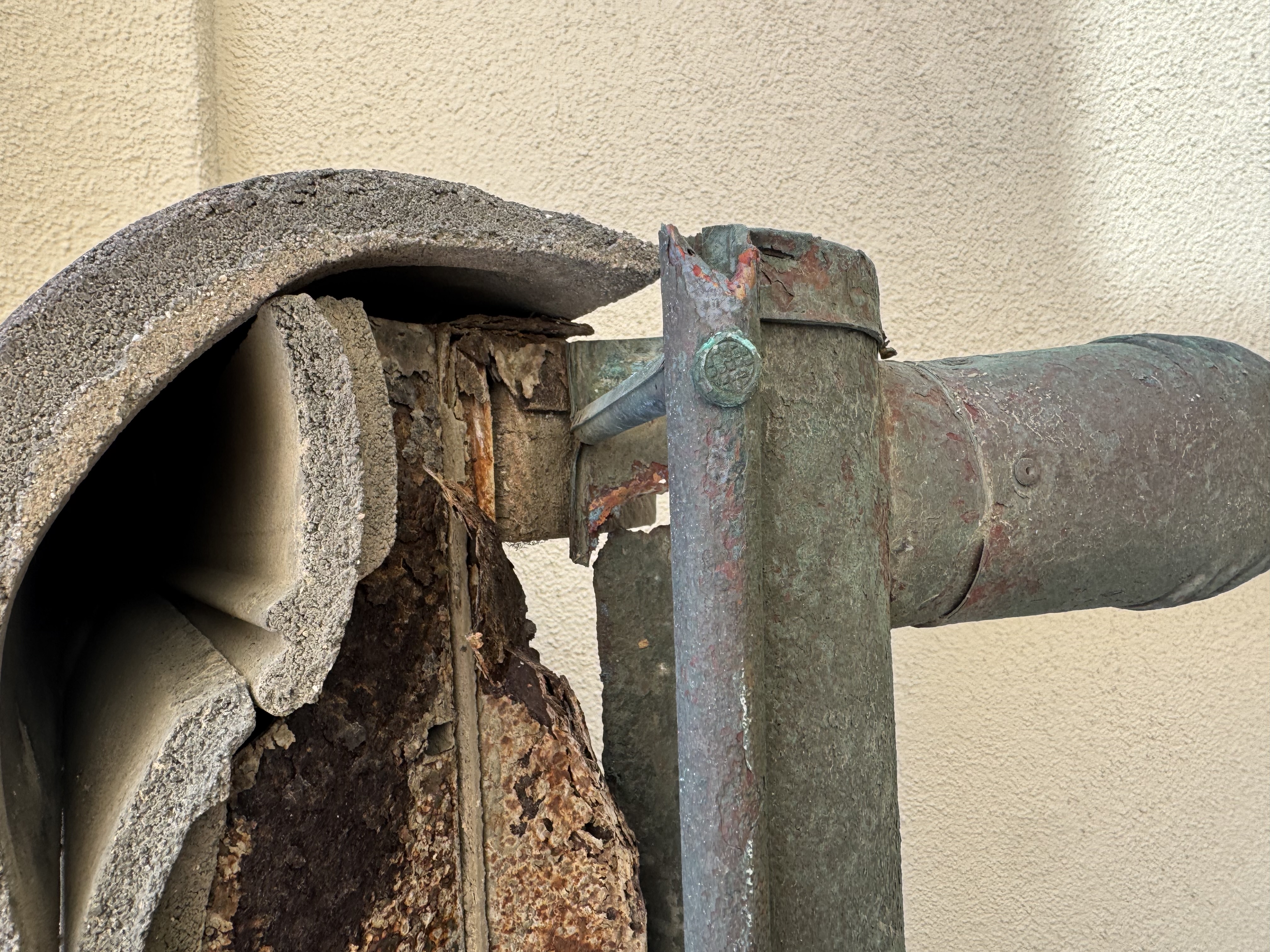 Before: rusted corroded copper downspout