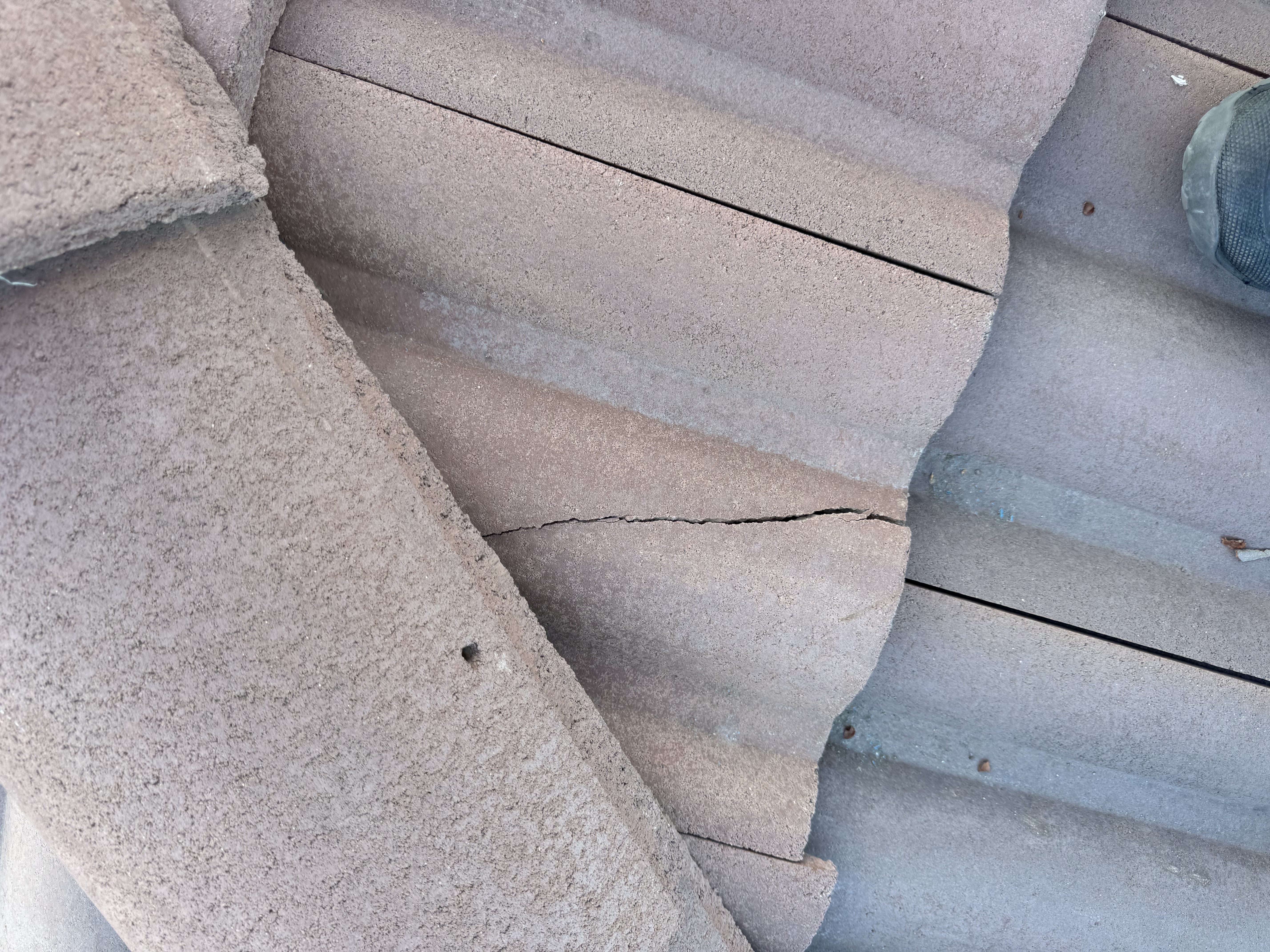 Close-up cracked concrete roof tile